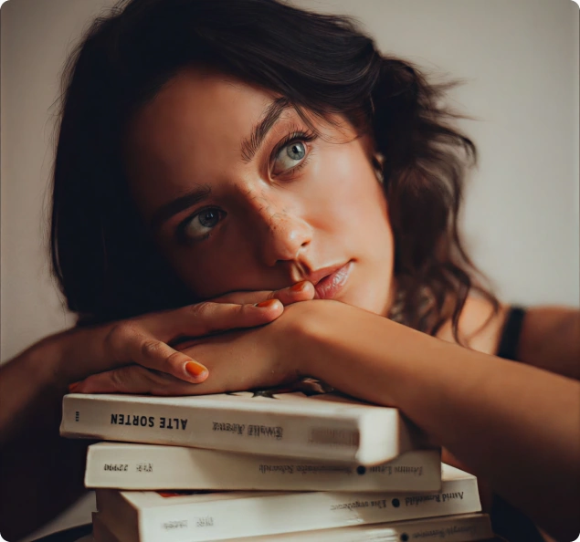 A reader resting on a stack of books